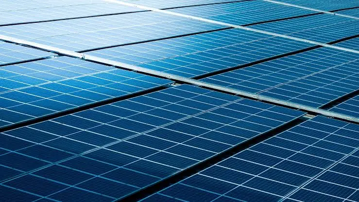 Close crop of blue polycrystalline modules showing the individual cells and the busbars running between them